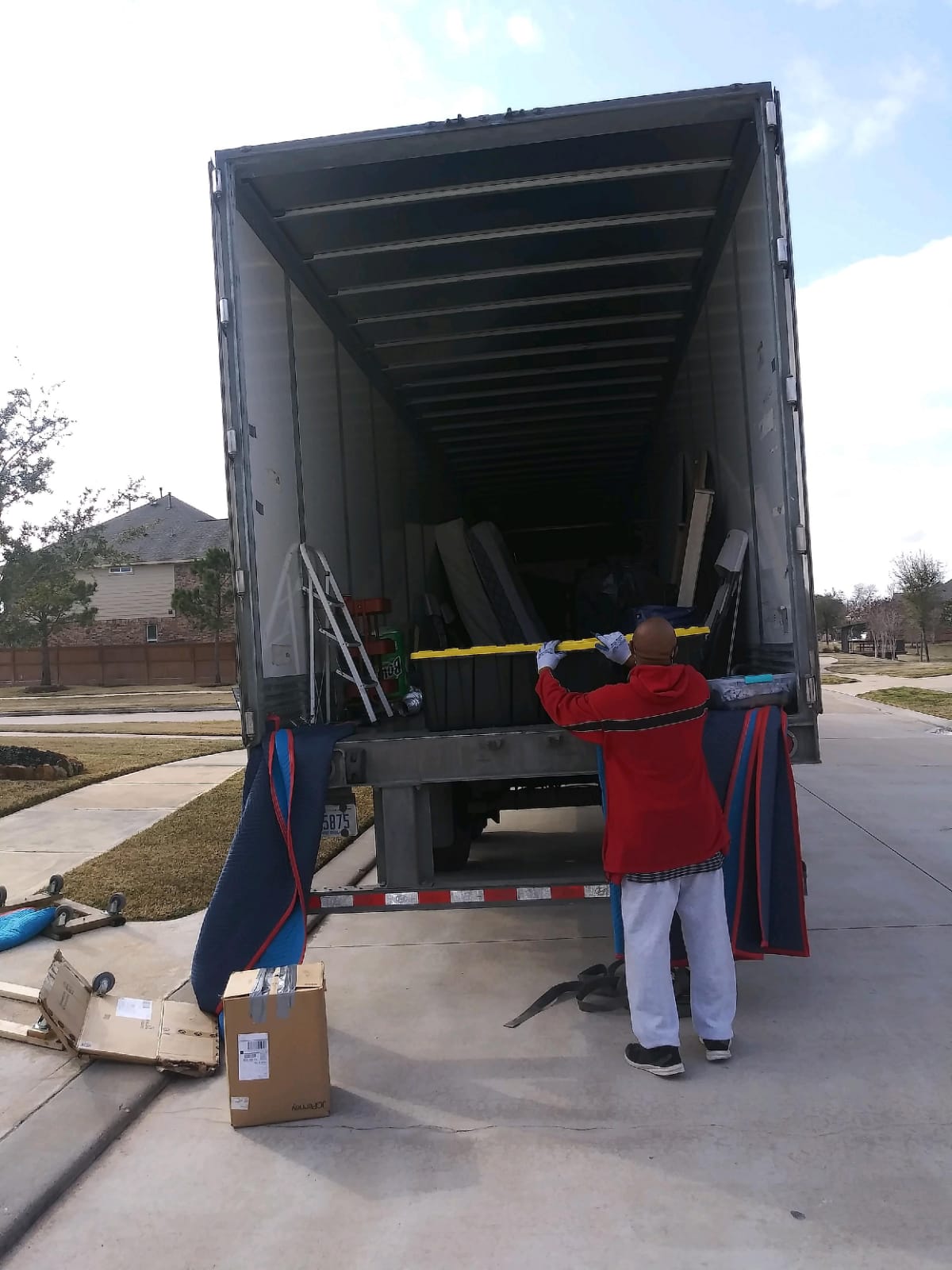 A man standing in front of a truck with boxes.