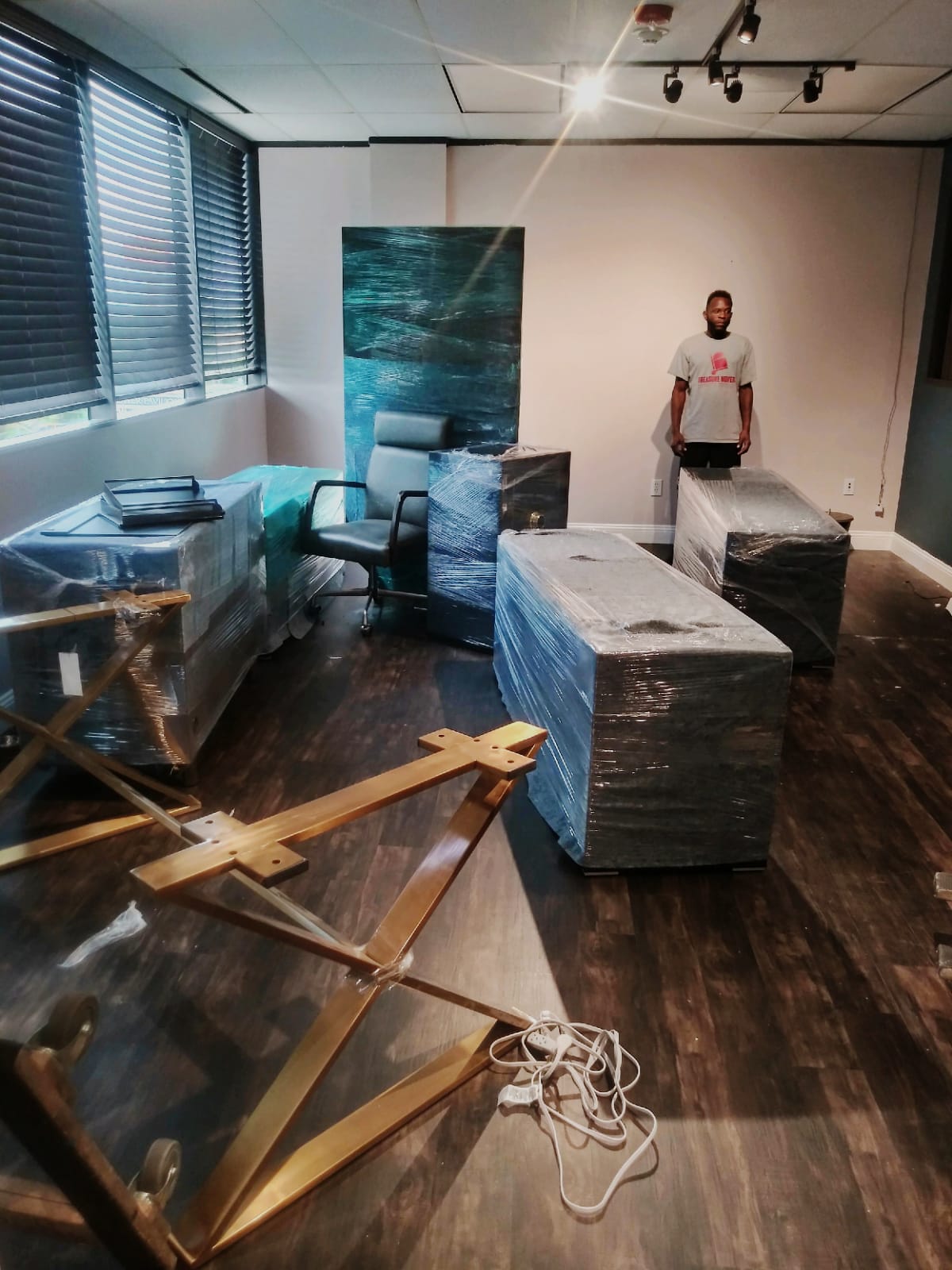 A man standing in front of some boxes on the floor